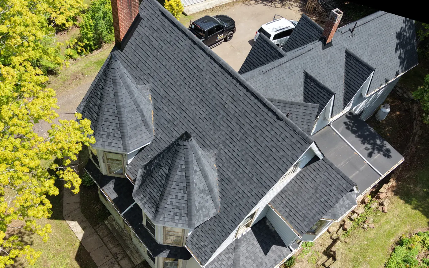 The same roof one year later with new architectural shingles, seen from directly above